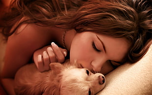 woman sleeping beside brown dog